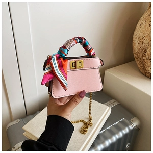 Detailed view of pink mini handbag with a silk scarf wrapped handle and gold lock