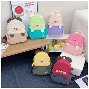 Detailed group view showing six colorful cartoon bear backpacks for kids in a playful setting
