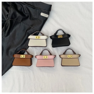 Mini trapezoid handbags for kids in five colors featuring golden twist locks and top handles