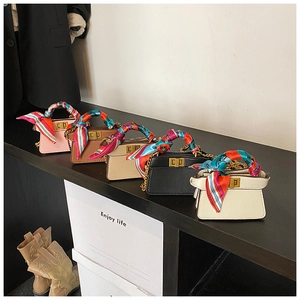 Detail of five mini chain handbags with decorative silk scarves and metal twist locks