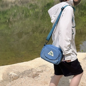 Kids navy blue outdoor crossbody bag with mountain logo and adjustable shoulder strap