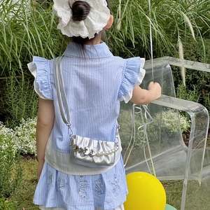 Sac à main argenté plissé pour filles avec perles et cœur porté par un modèle