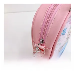 Close-up of pink leather kids bag featuring smooth metal zipper and floral puller