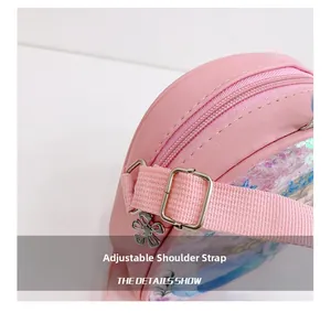 Detail showing adjustable woven shoulder strap and silver metal buckle on pink girl's bag