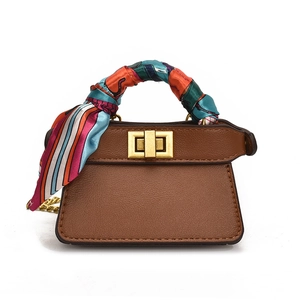 Mini brown leather crossbody bag with gold lock and silk scarf handle decoration