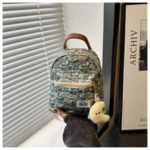 Detailed view of mini canvas backpack with ocean prints, starfishes and moon charm