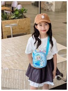 Little girl wearing light blue Frozen themed crossbody bag with Elsa and Olaf sequins