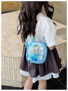 Blue sequin girls crossbody bag featuring cartoon characters with fuzzy pompom decor