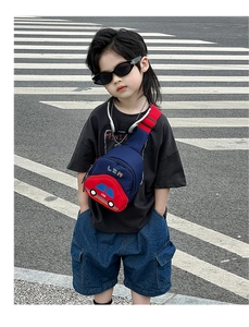 Detailed street style shot of kids car-shaped crossbody bag in red and blue colors