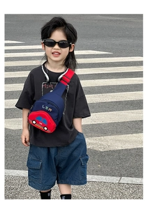 Detail of blue and red kids chest bag featuring 3D cartoon car and adjustable strap