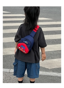 Detailed view of kids navy chest bag with 3D red car pocket and adjustable strap