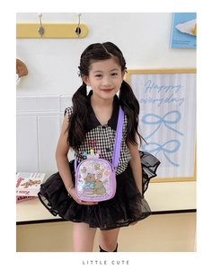 Detailed view of a purple sequined children's crossbody bag with bear and crown motifs