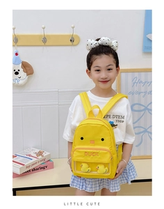 Close-up of cute yellow duck backpack featuring a clear PVC pocket and plush duck charms