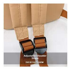 Detail view of the adjustable backpack shoulder strap with reinforced stitching and black buckle
