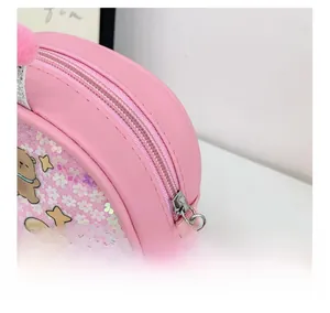 Detail shot of the smooth pink metal zipper and sequins on the kids Capybara shoulder bag