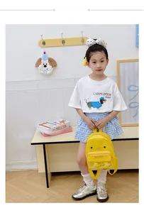 Detail showing toddler wearing a yellow cartoon duck backpack with clear front pocket