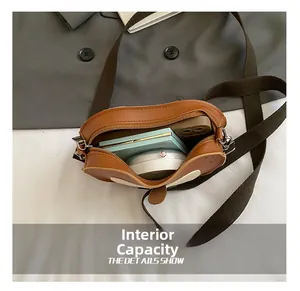 Detail view of mini apple-shaped bag internal capacity showing phone and makeup items
