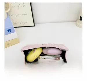 Pink lace crossbody bag interior showing storage capacity for small cosmetics and items