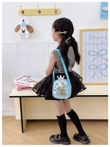 Close-up of blue kids crossbody bag with glitter transparent layer and crown detail