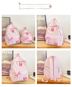 Detail view of pink plaid kids backpack with bow ties and side drawstring pockets