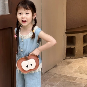 Close-up of cute apple-shaped crossbody bag for kids with premium leather texture