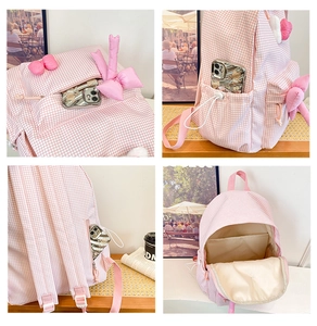 Detail view of pink plaid backpack featuring multi-pocket design and cute ribbon bow