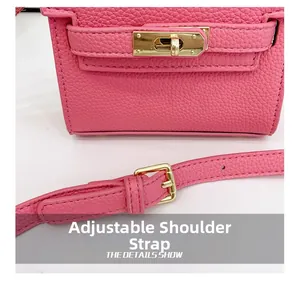 Detail of pink lychee leather handbag with gold metal clasp and adjustable strap