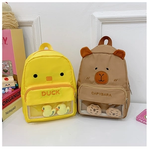 Detail of yellow duck and brown capybara backpacks with clear PVC display pockets