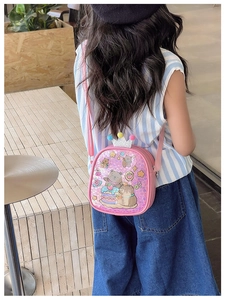 Detailed back view of a pink sequined crossbody bag for kids with cute cartoon patterns