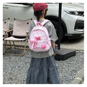 Pink and white checkered toddler backpack with decorative bows and adjustable straps