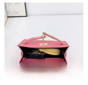 Detail showing the internal capacity of the pink leather mini bag with gold turn-lock