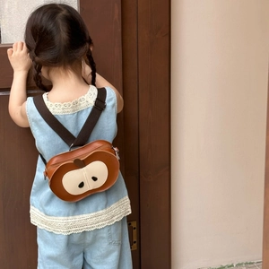 Mini apple-shaped backpack for kids showing the creative PU leather seed details