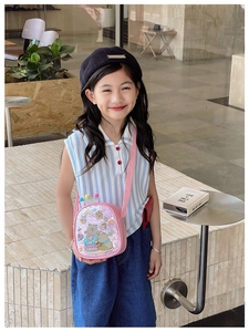 Pink sequin crossbody bag for kids featuring cartoon animal prints and colorful pom-poms