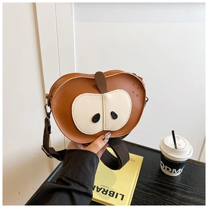 Close-up of apple-shaped kids crossbody bag with brown faux leather and white contrast