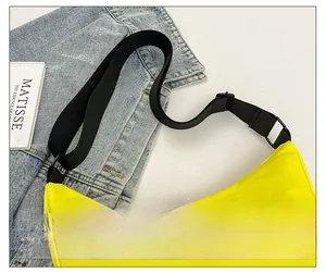 Close-up of yellow crescent crossbody bag with blue logo and adjustable black strap
