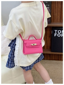 Pink lychee texture mini crossbody bag for kids with metallic twist lock and slim strap