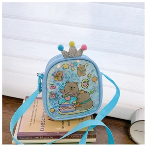 Close-up of sequined blue kids crossbody bag with bear print and crown detail