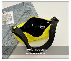 Detailed interior of yellow nylon crossbody bag with black lining and zip pocket