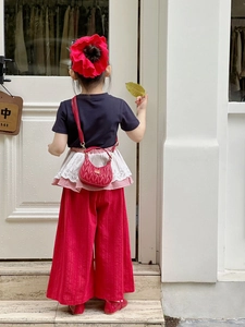 Detail showing a stylish red quilted mini handbag with gold chain for children fashion