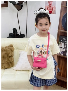 Detail of pink lychee leather mini crossbody bag with metal twist lock for kids