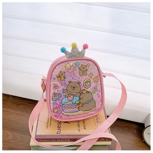 Detail of pink kids crossbody bag with cartoon bear prints and sequined crown decoration