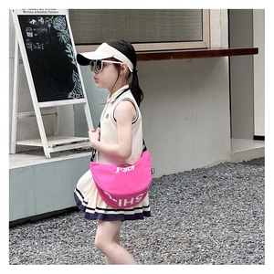 Pink crescent-shaped canvas crossbody bag for children with adjustable black strap
