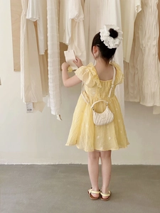 Detail of yellow embroidered cotton dress for girls with elegant ruffled sleeves back view