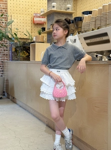 Detail of pink pleated handbag with silver brand logo for little girls fashion accessories