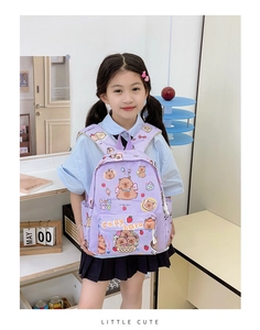 Girl wearing a purple plaid backpack with cute cartoon capybara prints in a bright room