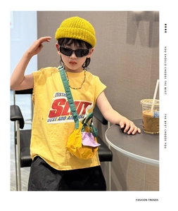 Close-up of kids bright yellow sleeveless T-shirt with SLIT artistic letter printing