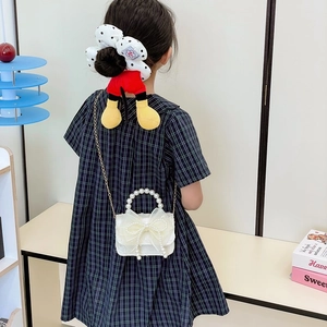 Kids pearl handle white crossbody bag with mesh bow and Disney-style hair scrunchie
