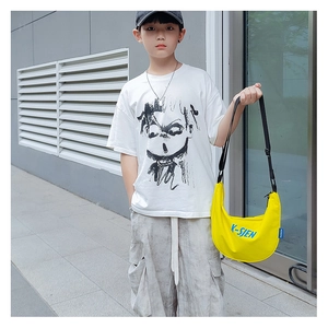 Detail of yellow nylon dumpling crossbody bag with adjustable strap and K-SJEN lettering