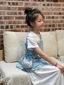 Close-up of children's silver pleated hobo bag with metallic finish and metal logo detail