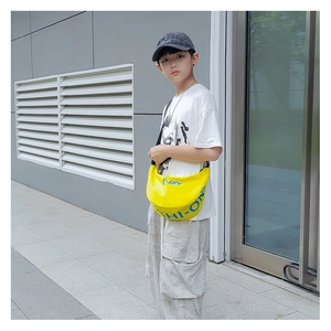 Close-up of bright yellow dumpling bag for kids with blue lettering and adjustable strap